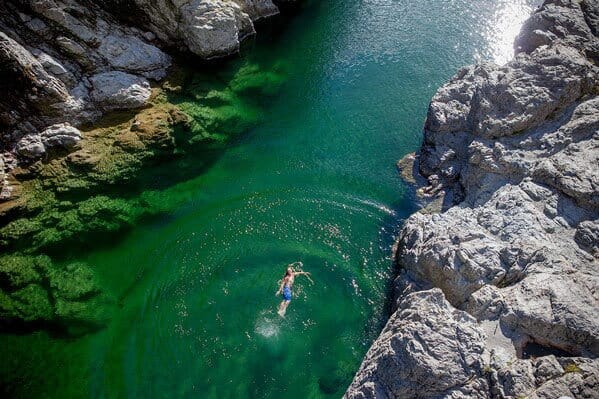 Woman swimming in clear river water | Hustler Equipment works for sustainability to preserve such waters | New Agricultural Innovation | Farm Machinery Technology