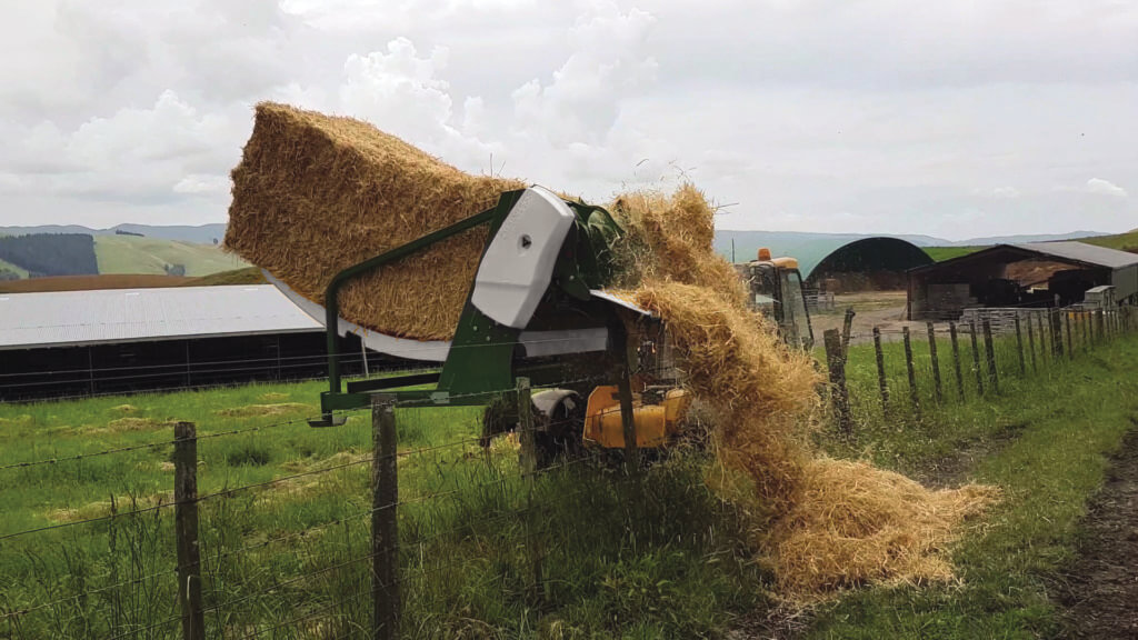 Feeding square bales over a fence