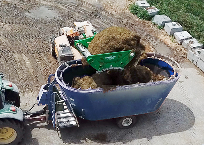 Unrolla LX105 bale feeder feeding into TMR.